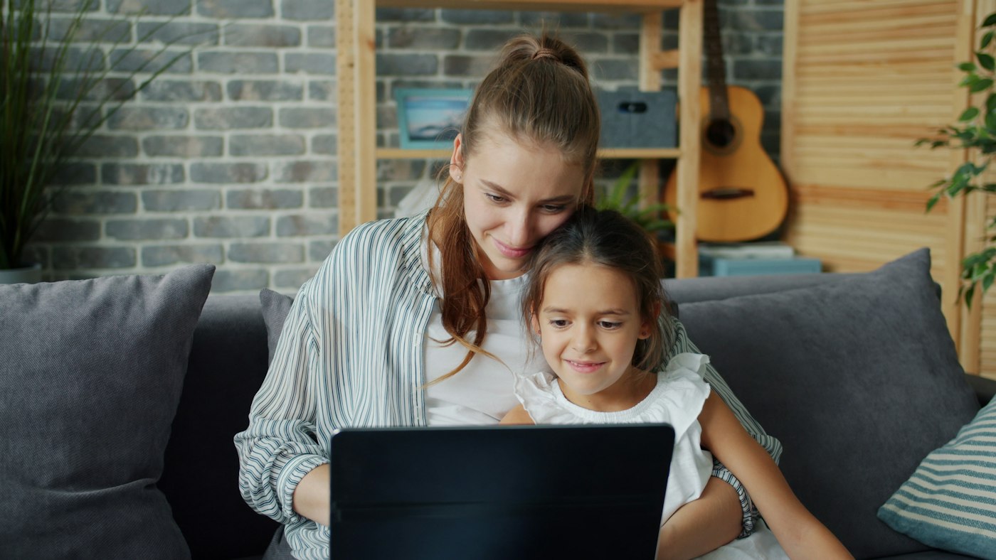 A family at home using a laptop together